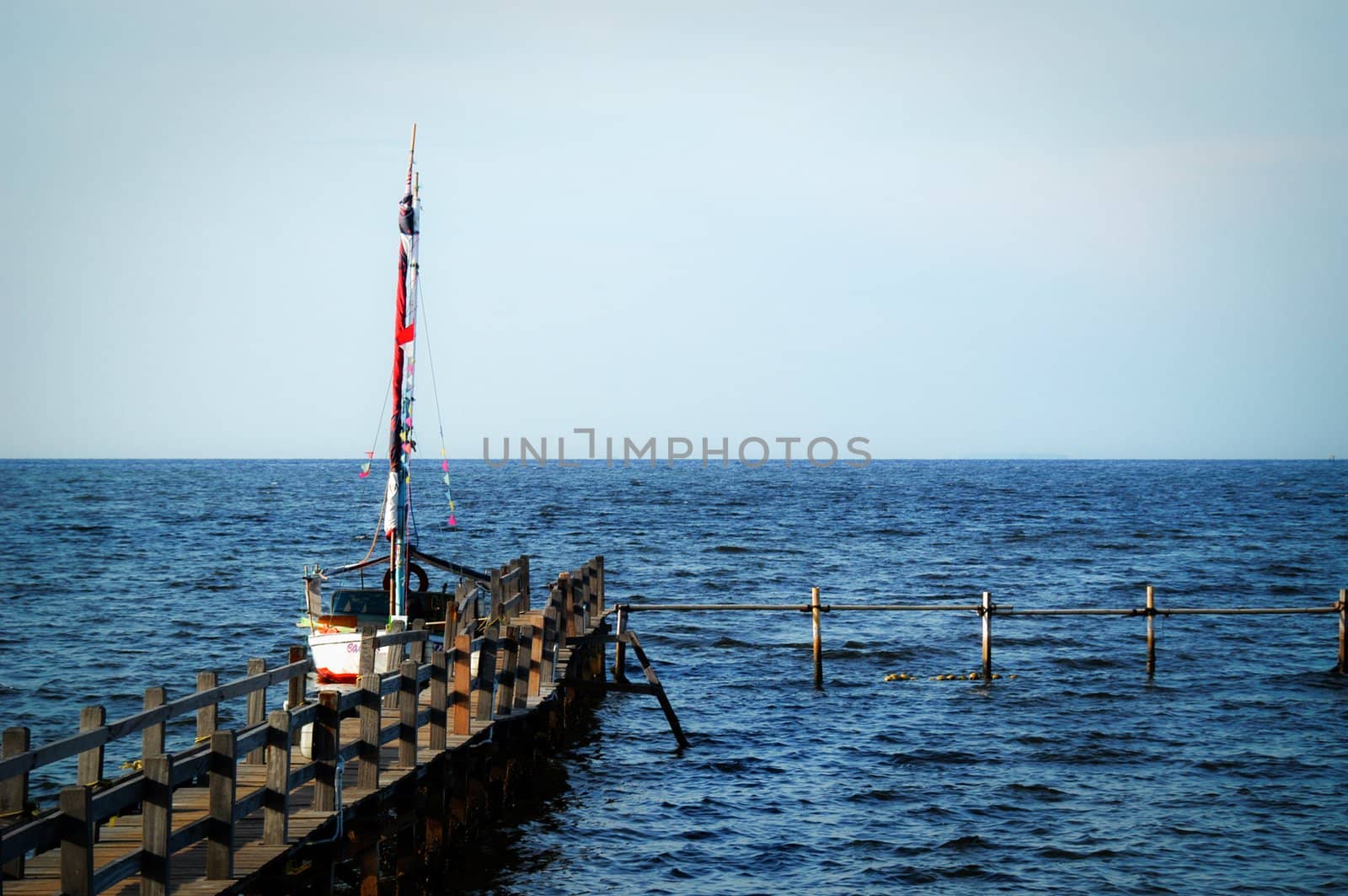 A scenic view of bridge, sea, and boat