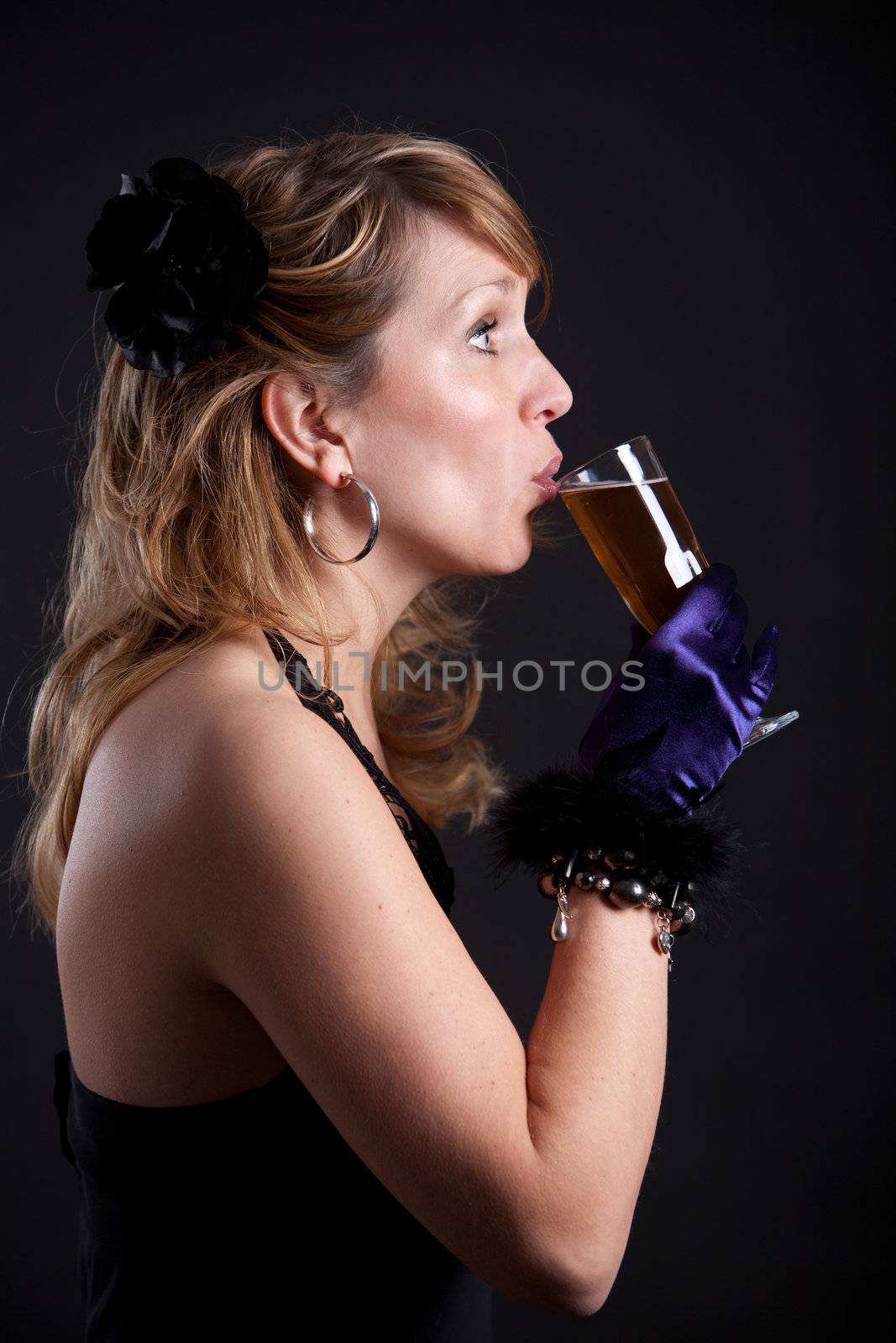 Pretty blond woman taking a sip from her glass