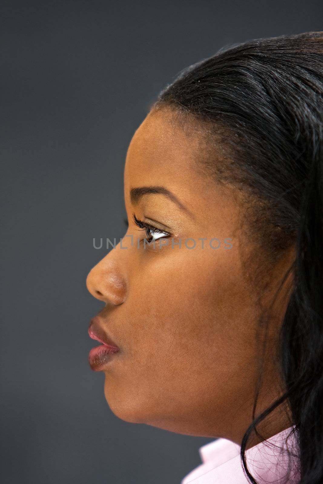 Side Portrait of a beautiful African-America woman in white shirt, isolated