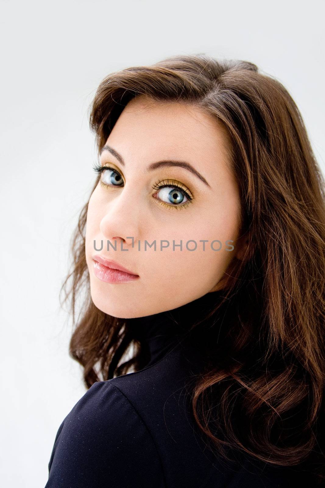 Face of a beautiful blue eyed brunette, isolated