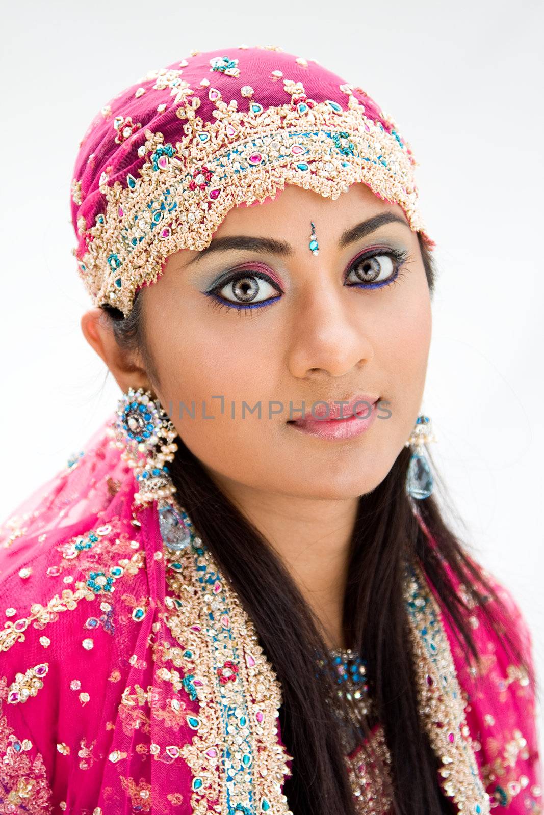 Beautiful Bengali bride in colorful dress, isolated