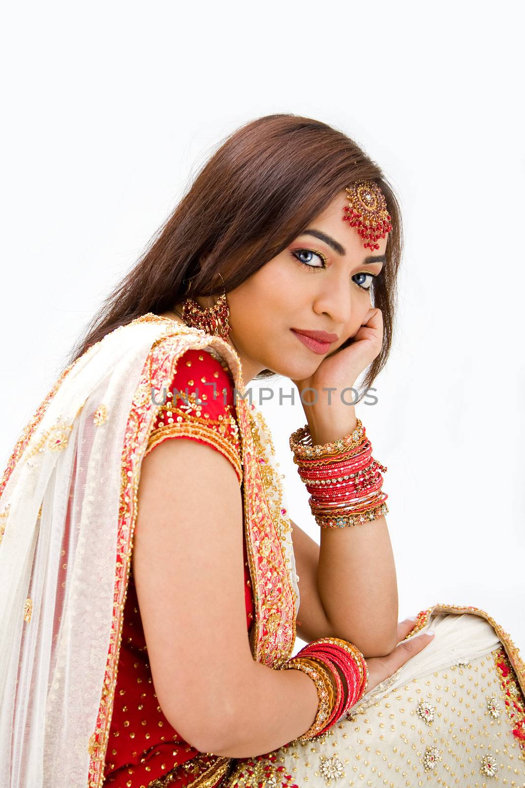 Beautiful Bengali bride in colorful dress day dreaming, isolated