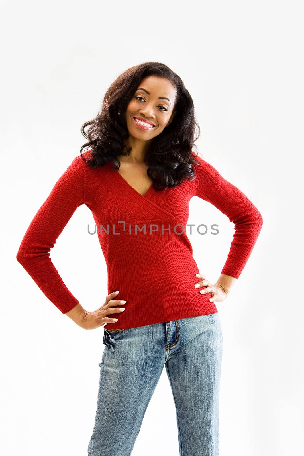 Beautiful African woman standing with hands on hips and smiling, isolated