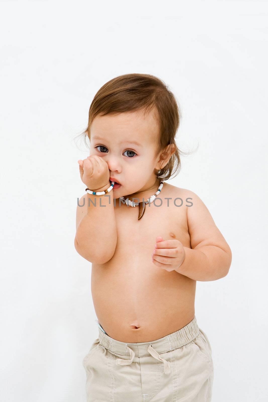Cute and smiling topless toddler boy with necklace, isolated