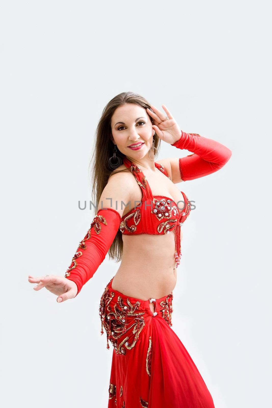 Beautiful belly dancer in red outfit, isolated