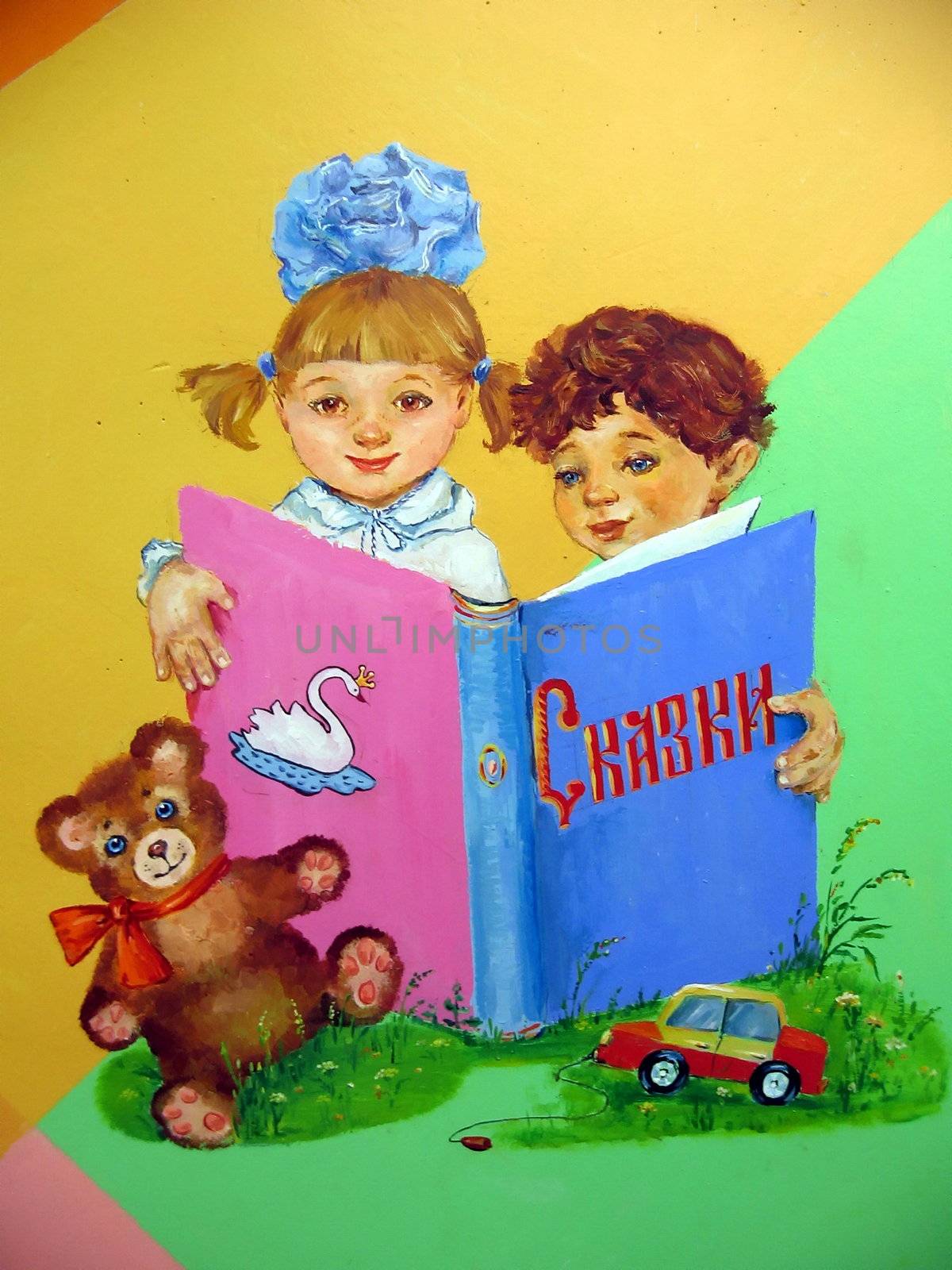 Painted on the colored wall boy and girl which read book