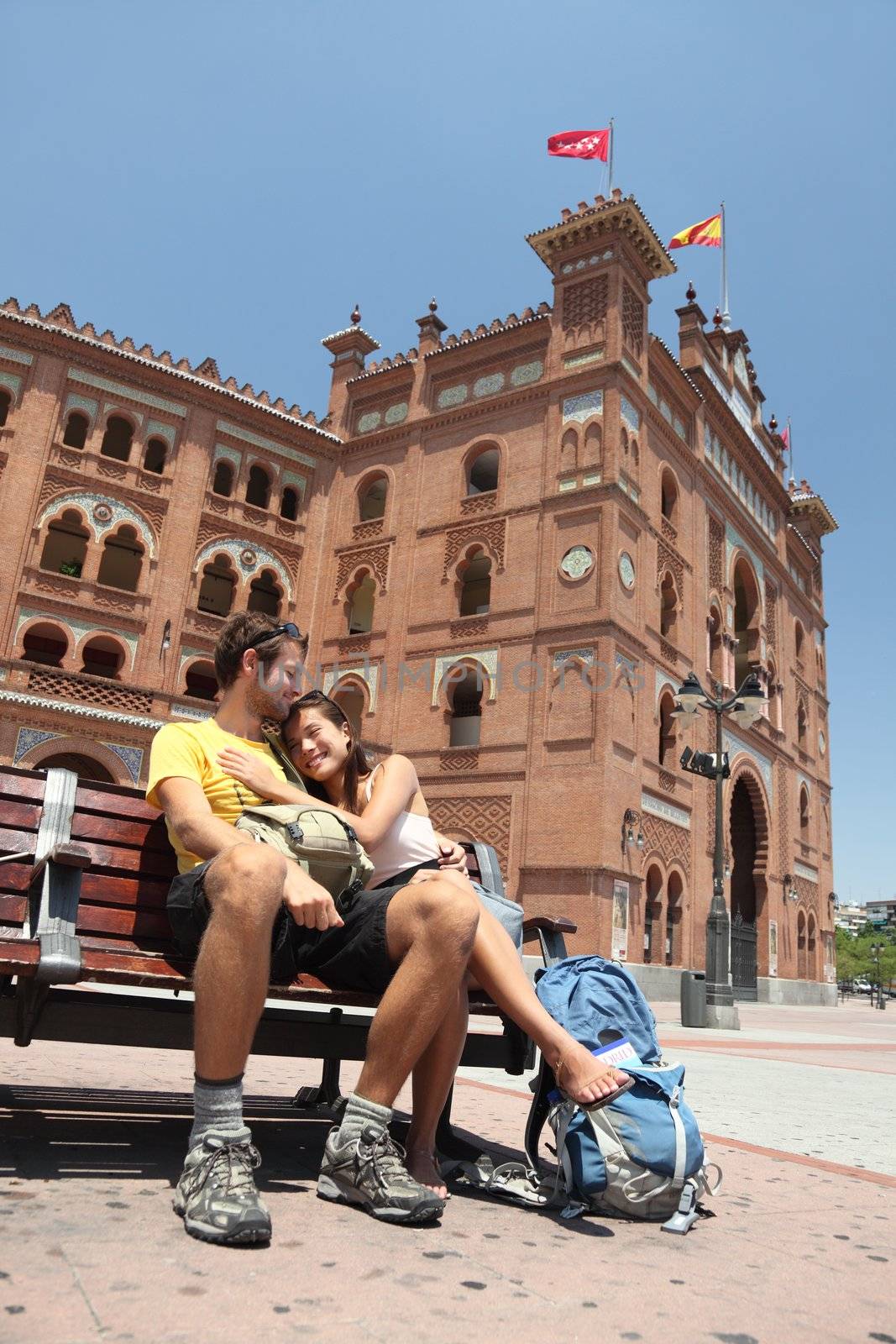 Happy couple travelling in Spain, in front of the bullfighting arena Plaza de Toros de Las Ventas in Madrid.