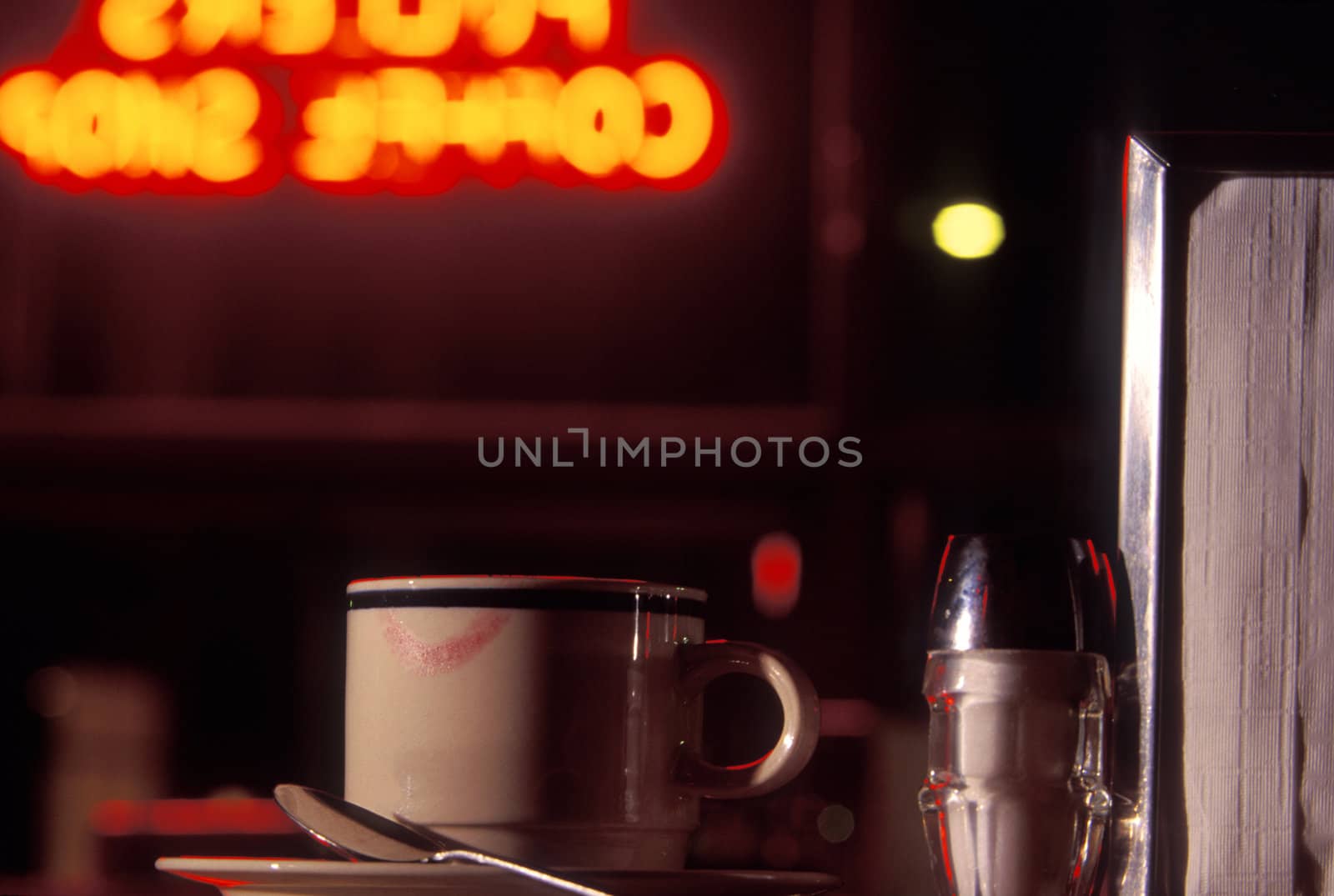 Diner at night, closeup of coffee mug with lipstick kiss