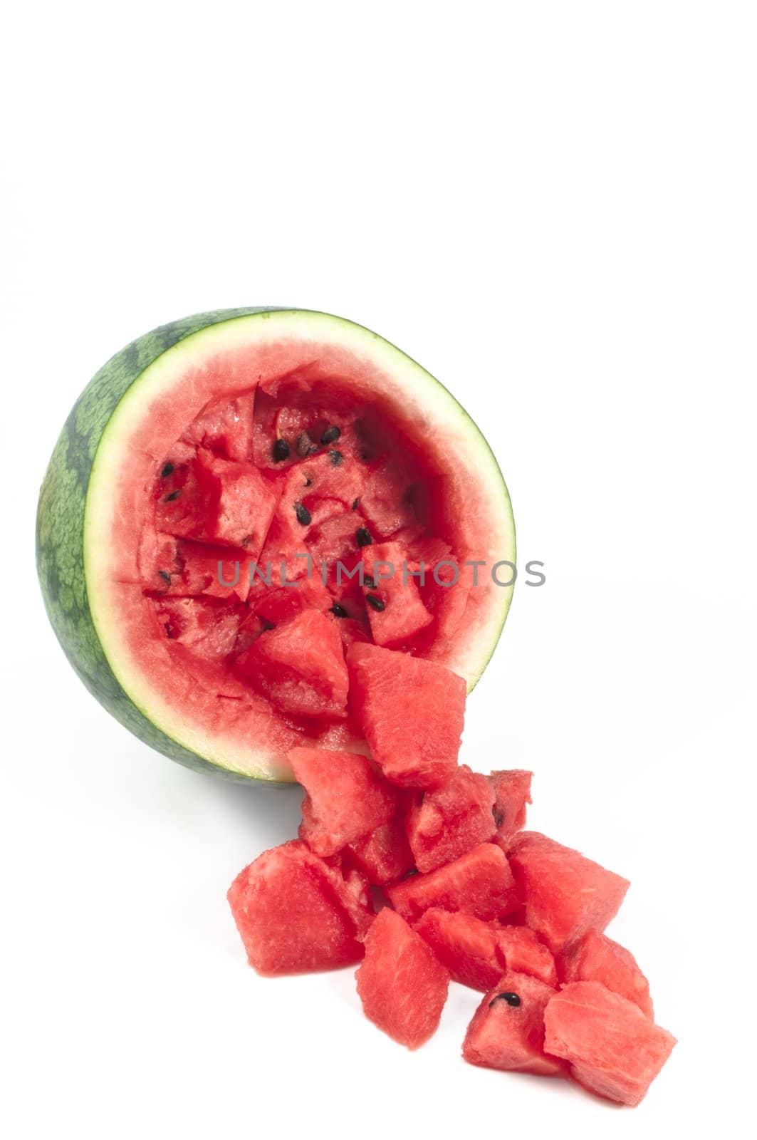 Watermelon pieces in front of a sliced watermelon isolated on white