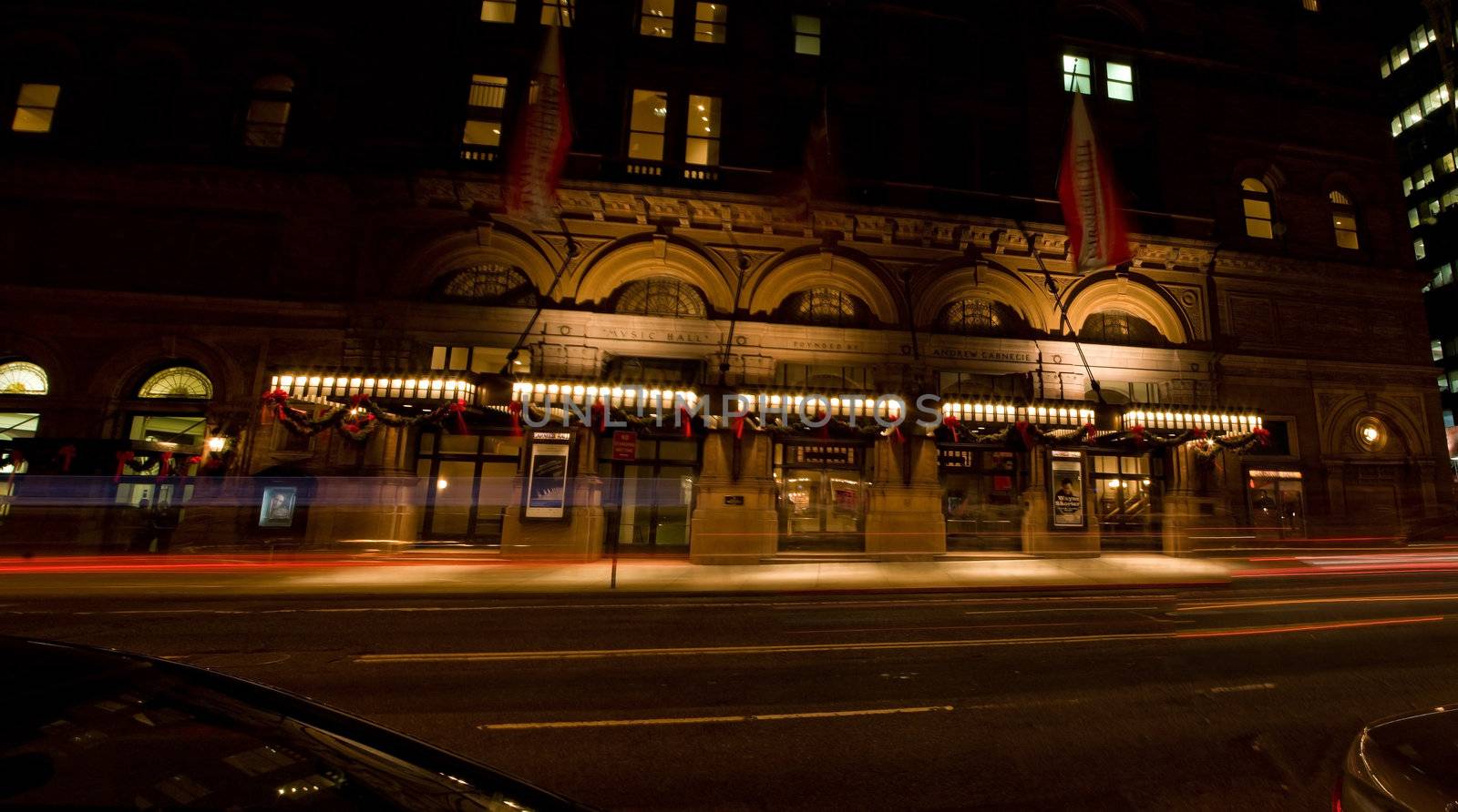 The famous Carnegie Hall, home of the New York Philharmonic Orchestra, by night at 57th street and 7th avenue