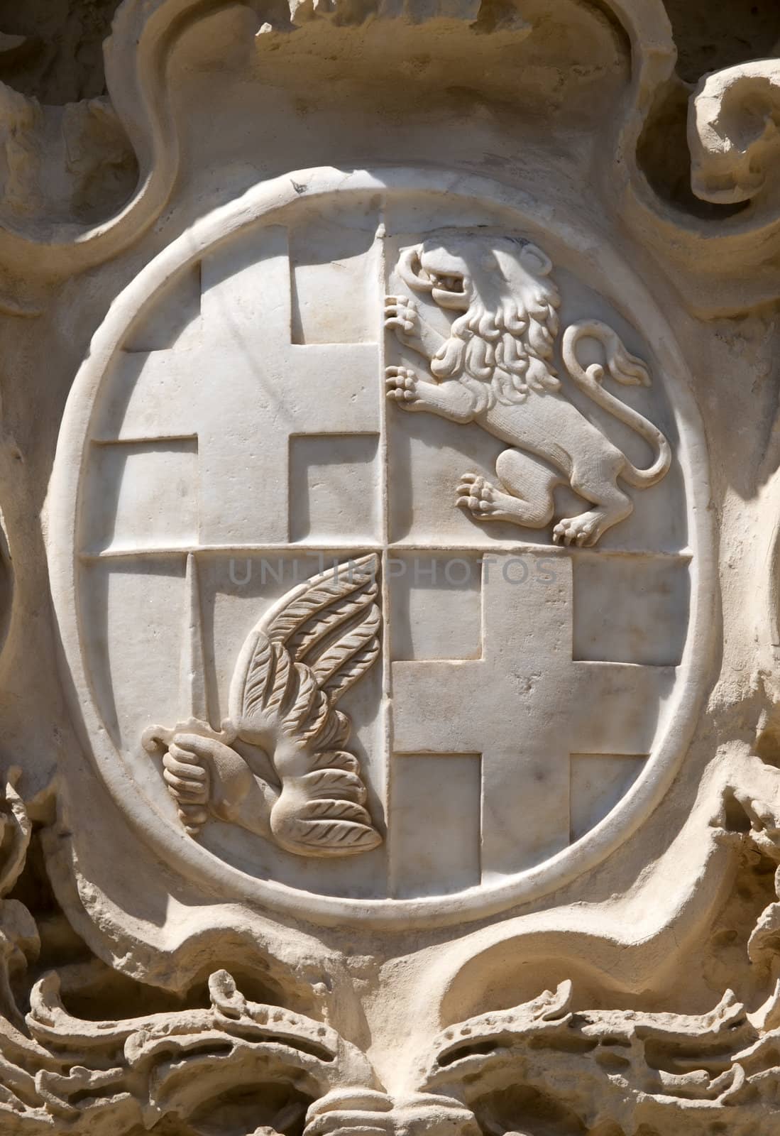 Coat of arms carved in marble abobe the gate when entering the old city of Mdina in Malta
