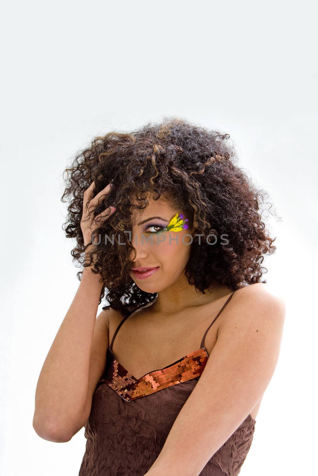 Beautiful brunette in brown shirt with yellow flower and purple eyeshadow, isolated