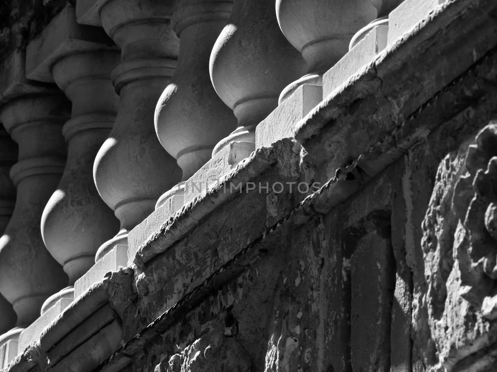 Detail in monochrome of stone balustrades on a balcony in Malta