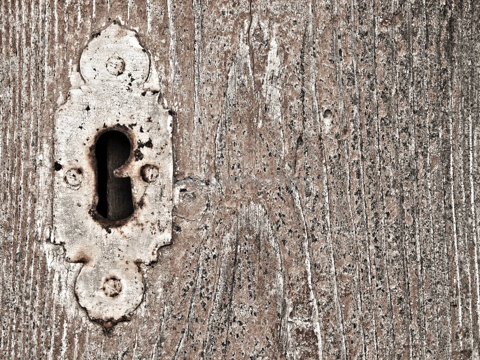 Detail image of an old wooden door and old keyhole