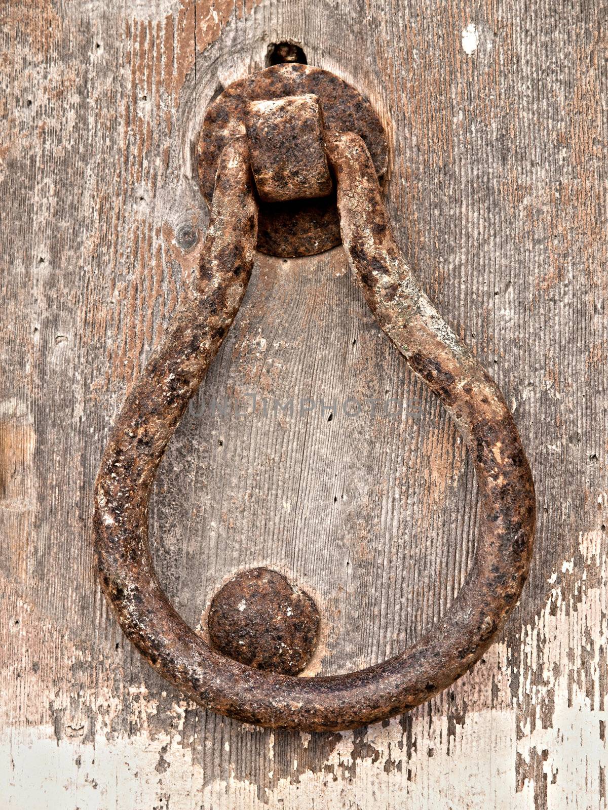 Detail image of an old wooden door and iron dorrknocker in Mdina