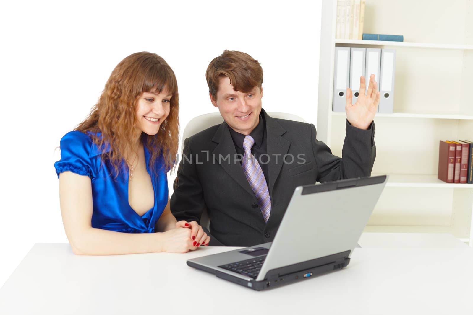 Man and woman are happy looking at a laptop screen in office