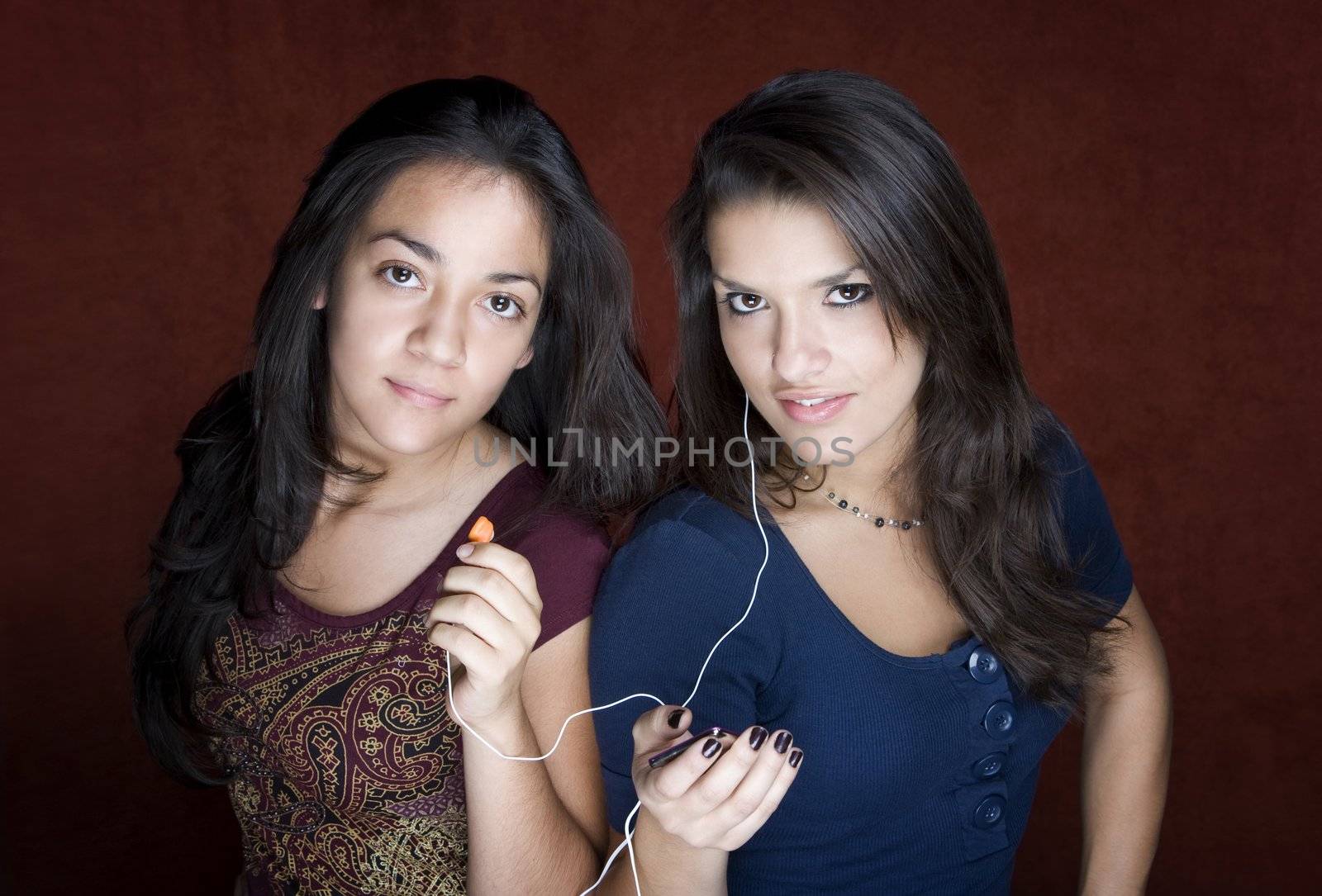 Two young women listening to music by Creatista