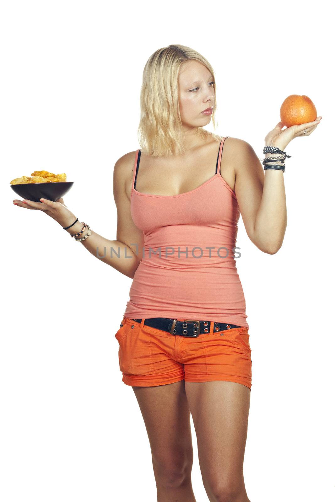 Attractive girl deciding to eat junk food or fruit by Jaykayl