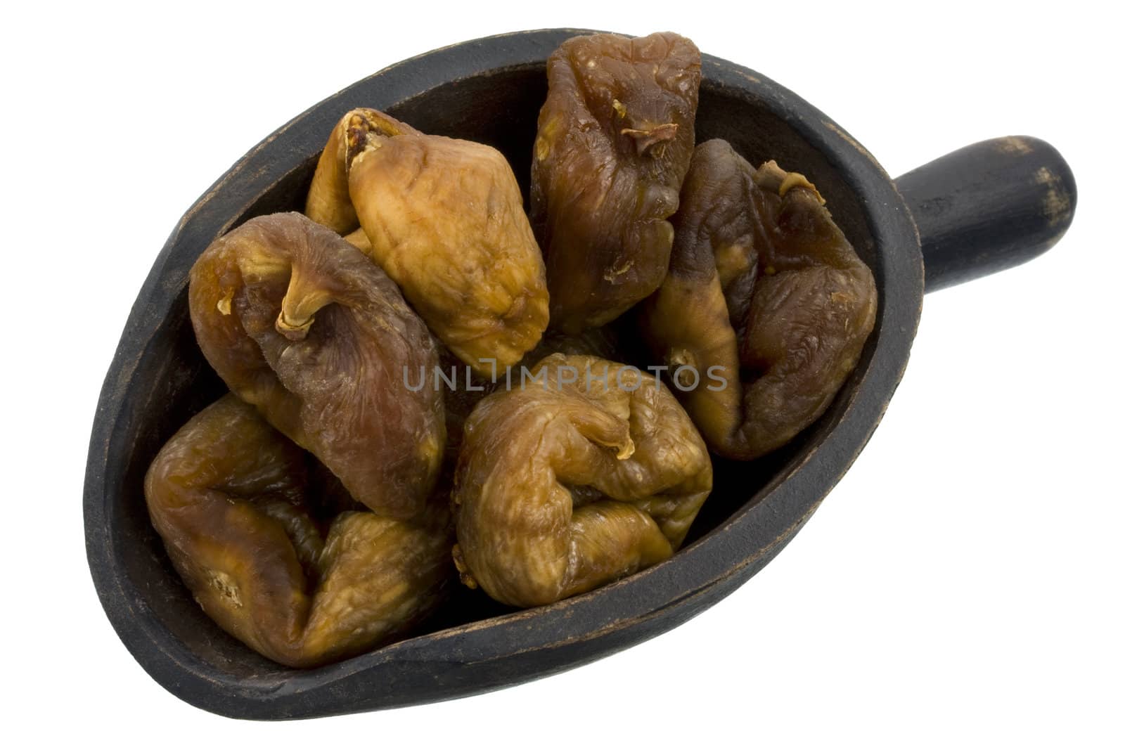 dried Turkish figs on a rustic, wooden scoop, isolated on white