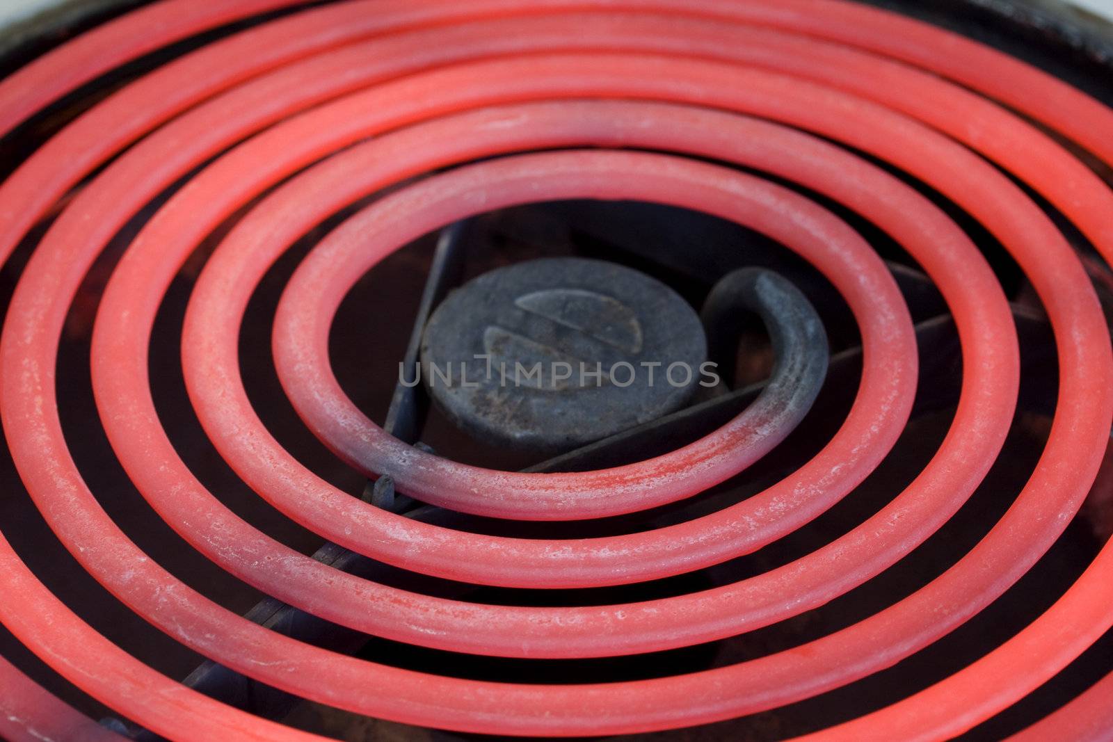 close-up of red glowing heating element of electirc range oven, selective focus
