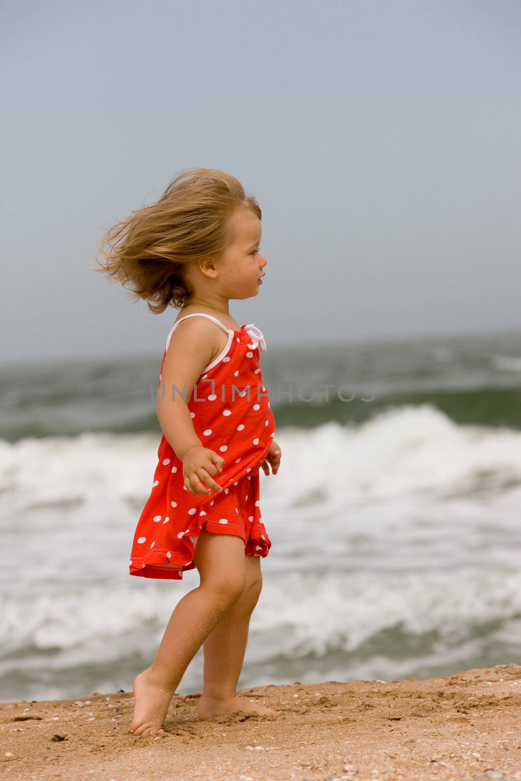 people series: little girl on sea beach in red dress