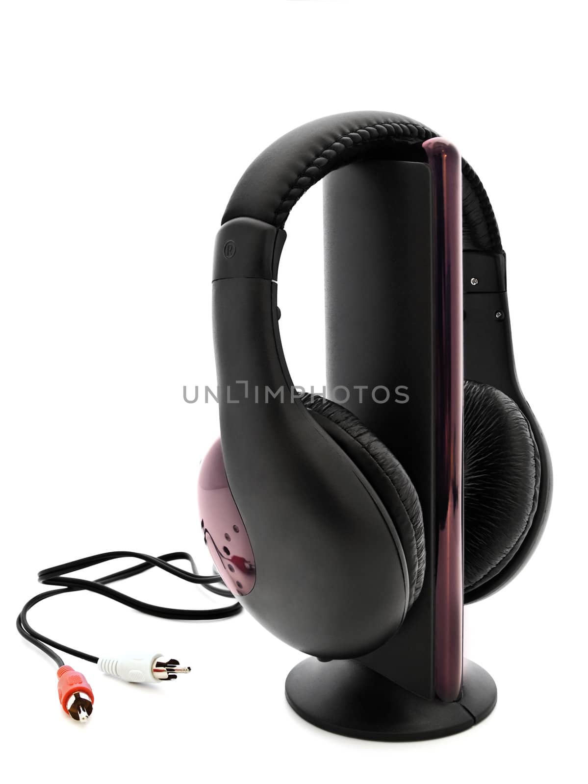 Modern black headphones at stand over white background 