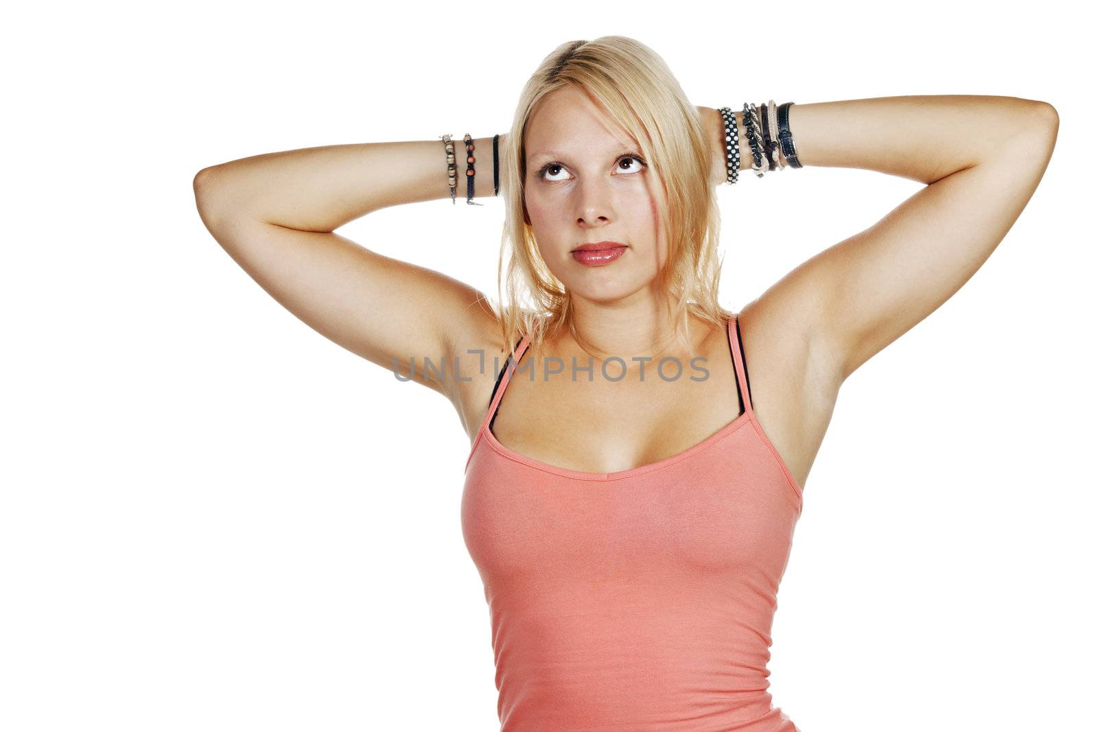 Portrait of young beautiful blonde woman relaxing and thinking with her hands behind her head. Isolated on white.