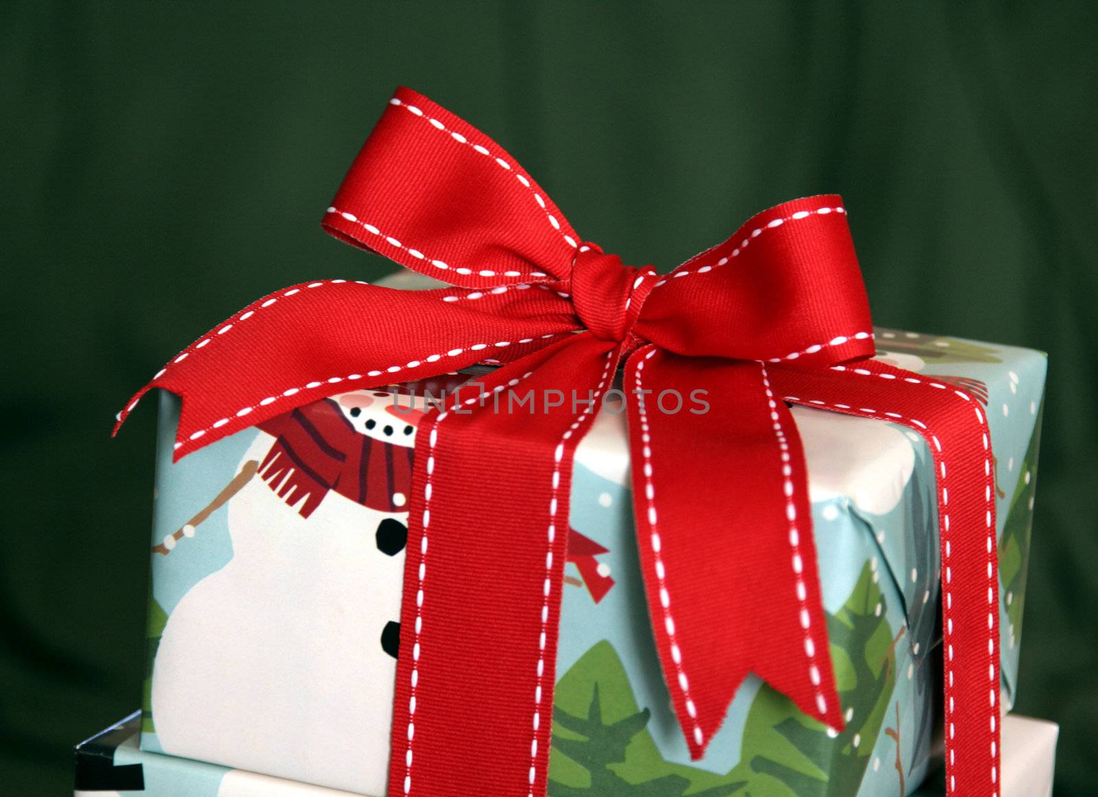 A large Christmas present wrapped with a red ribbon.