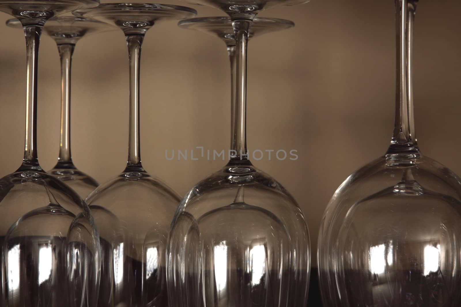 Lots of wine glasses sitting on a shelf.
