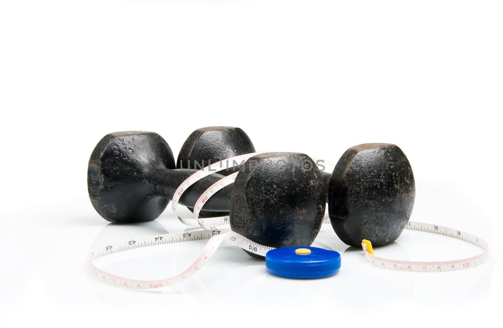 Old iron dumbbells and tape measure, white background