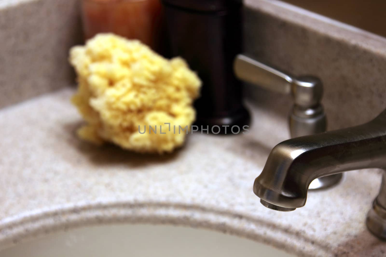 A luxurious bathroom counter top with the tap in focus.