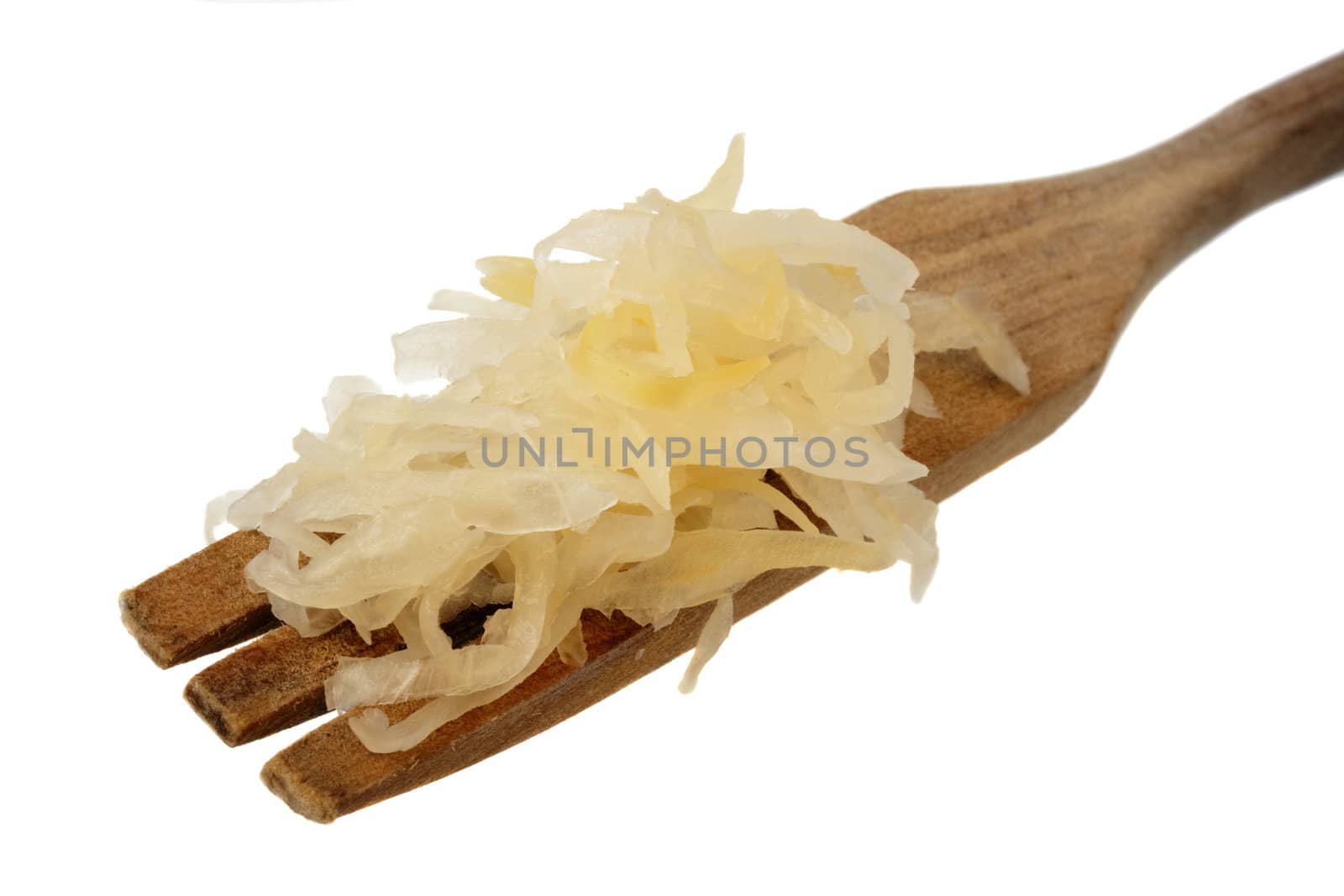 sauerkraut (fermented cabbage) on a wooden fork isolated on white