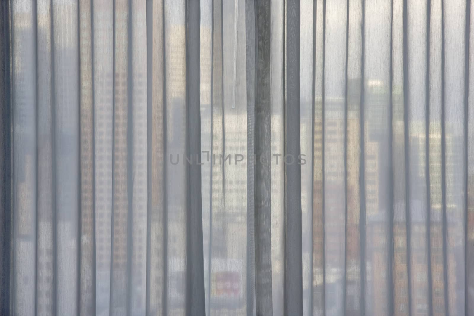 cityscape through window curtain by PixelsAway
