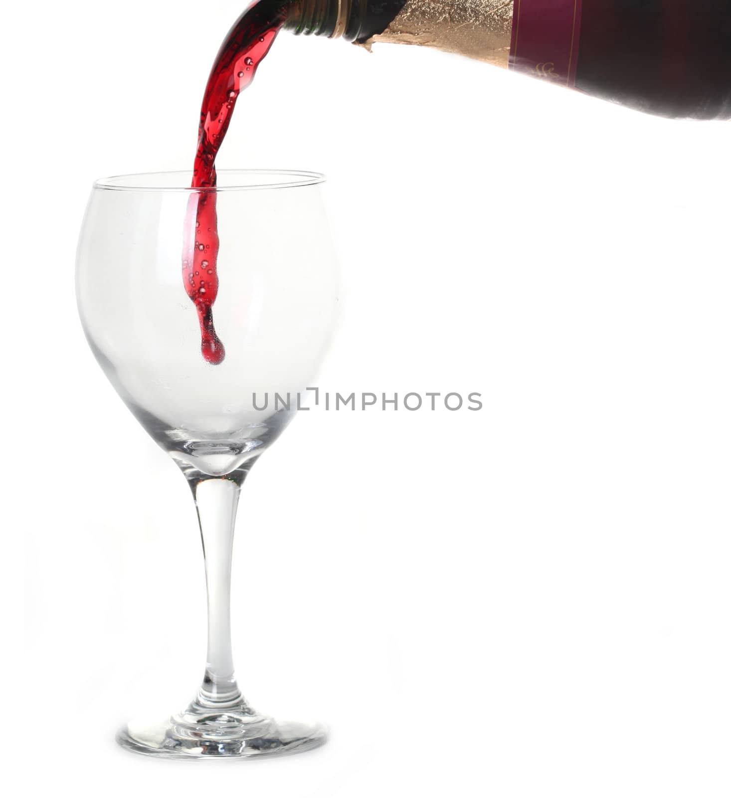 Red Merlot Wine Pouring into a Chilled Glass on White Background With Copy Space