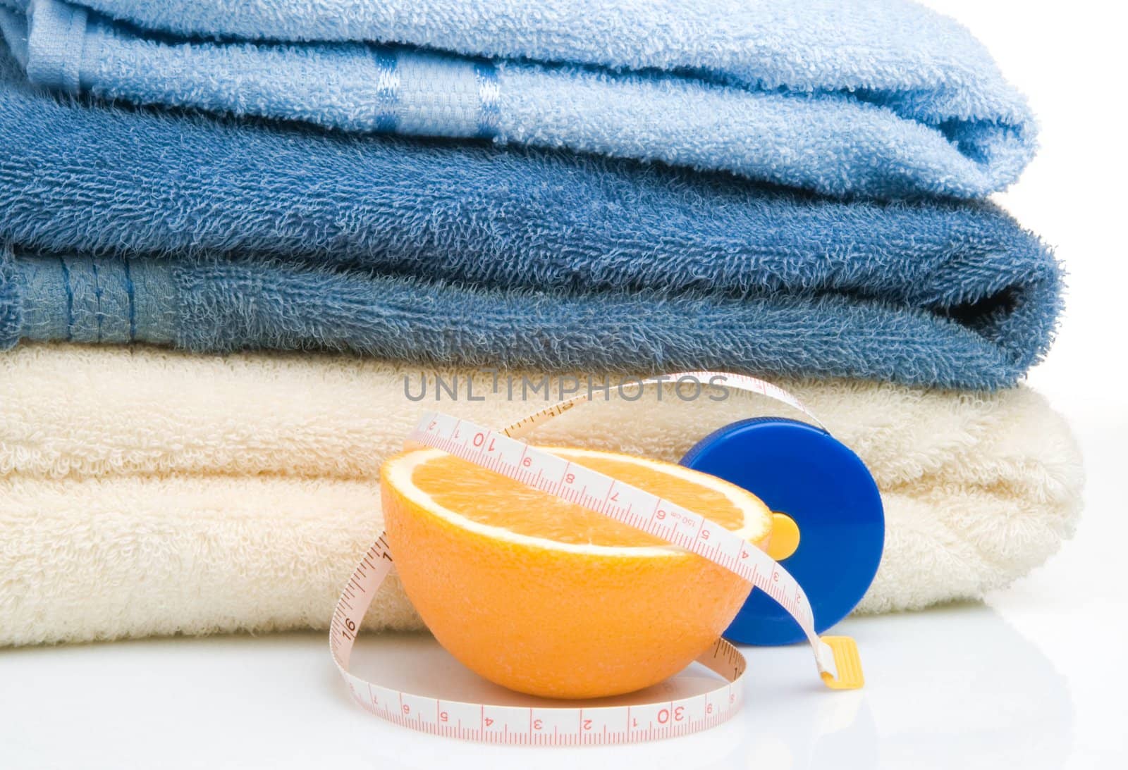 Pile of towels, tape measure and half of orange