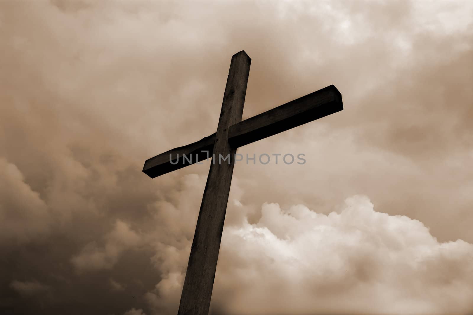 rustic wooden cross against dramatic sky