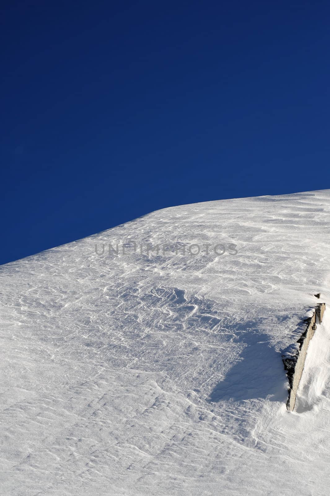 Sparkling snow covered mountain peak on a clear cloudless day, image contains GPS location information