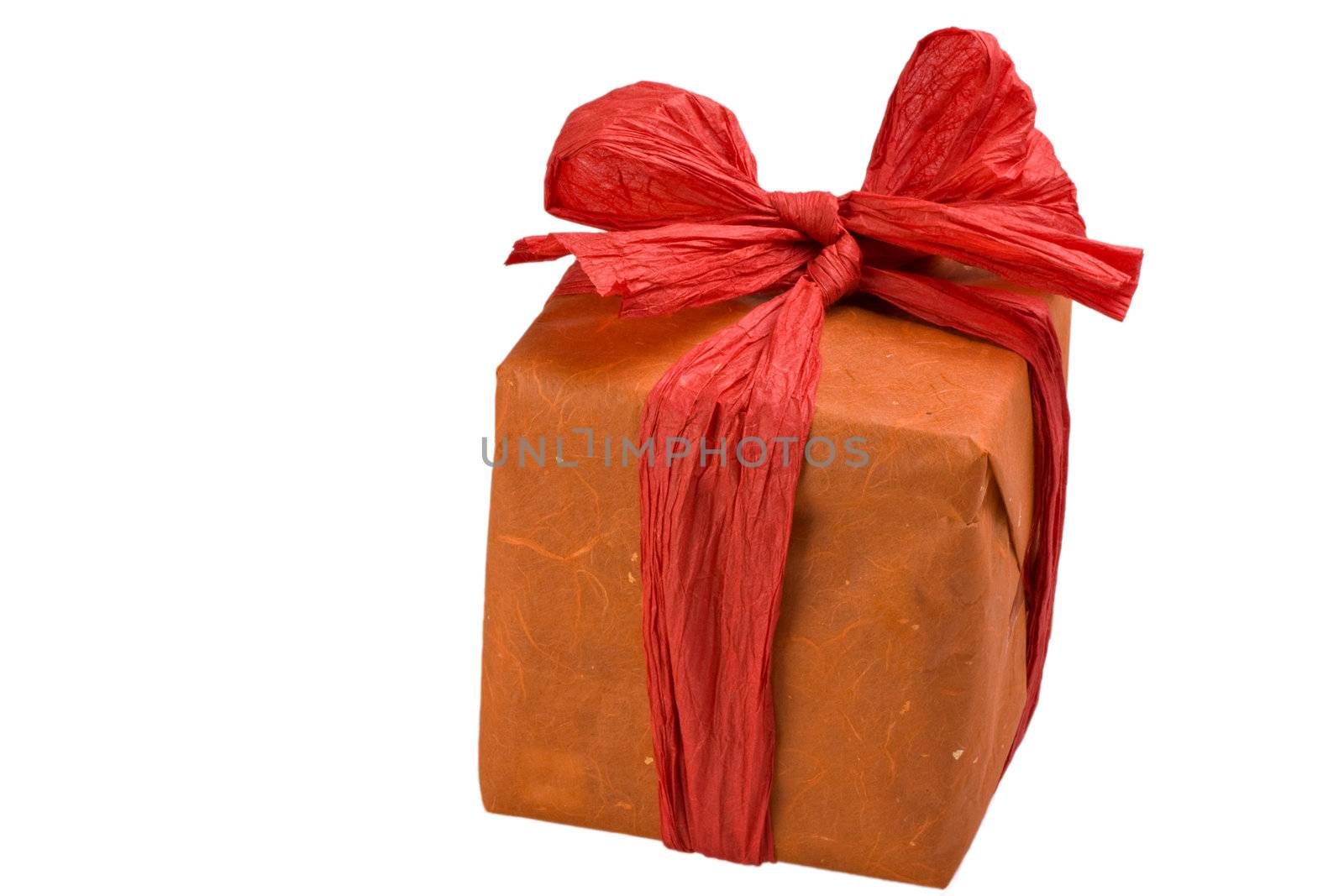 gift wrapped in orange paper with a red bow