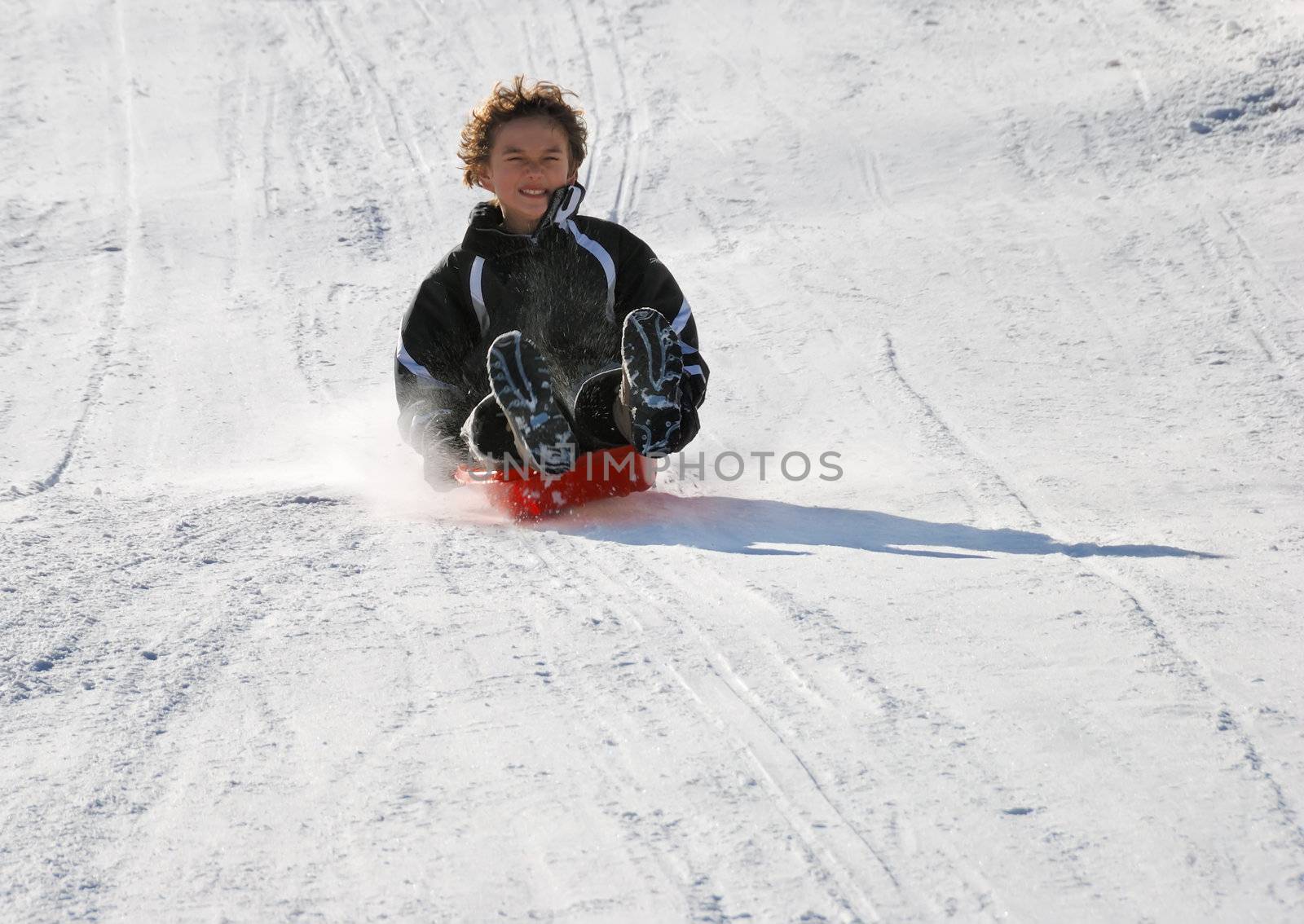 Scared Boy Sledding Fast Down the Hill by goldenangel