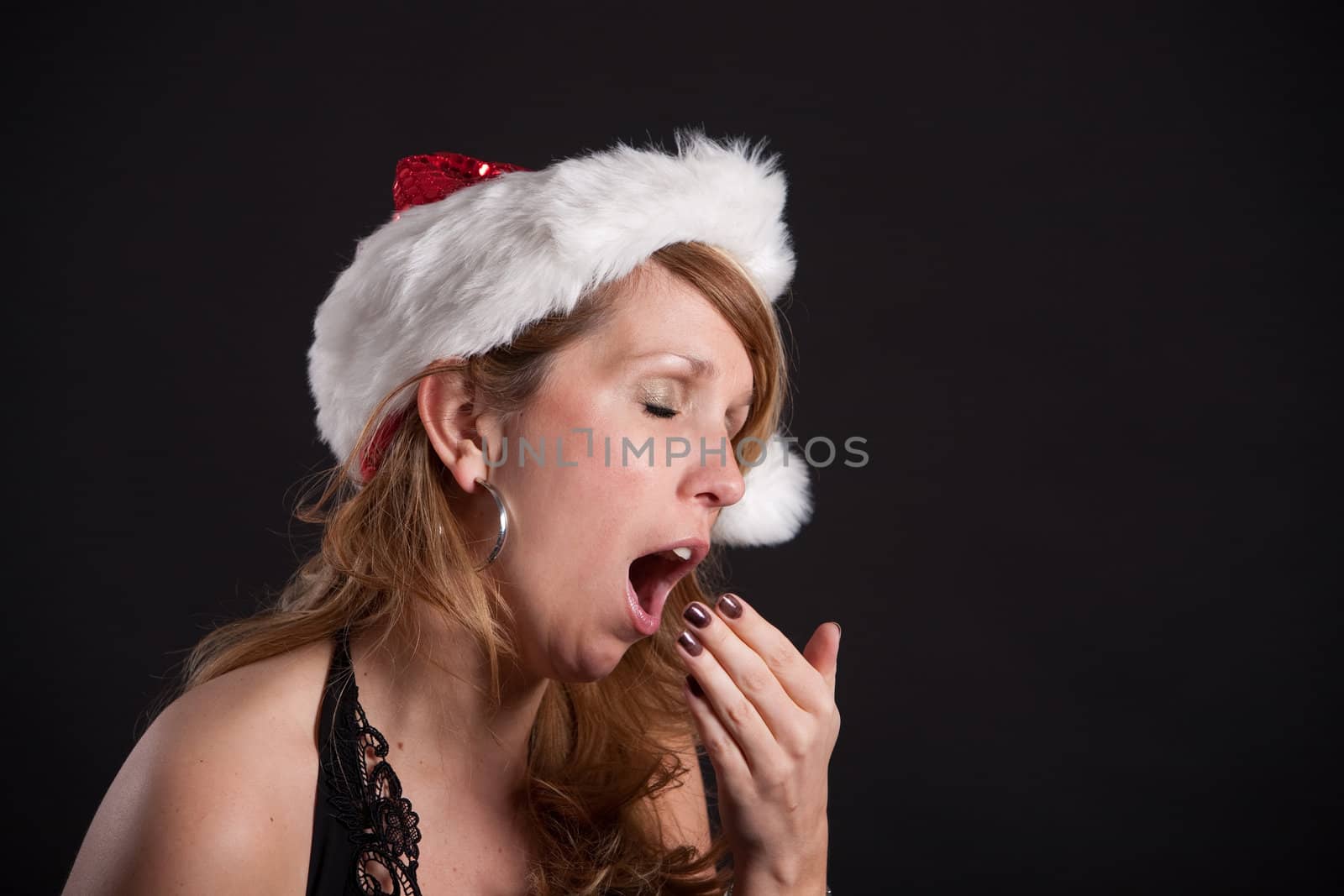 Attractive blond female yawning with mouth wide open at party
