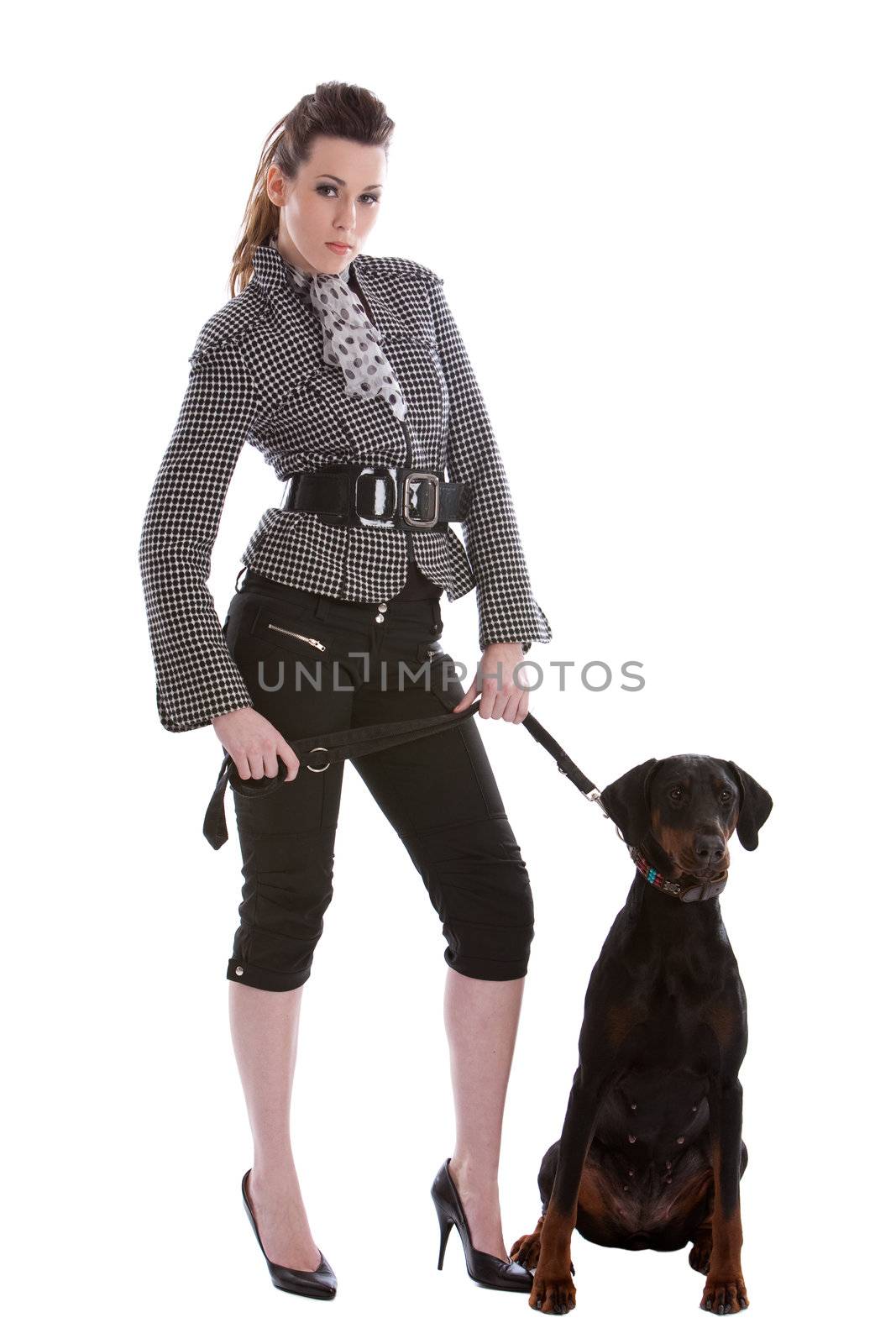 Pretty fashionable woman letting her doberman pincher out