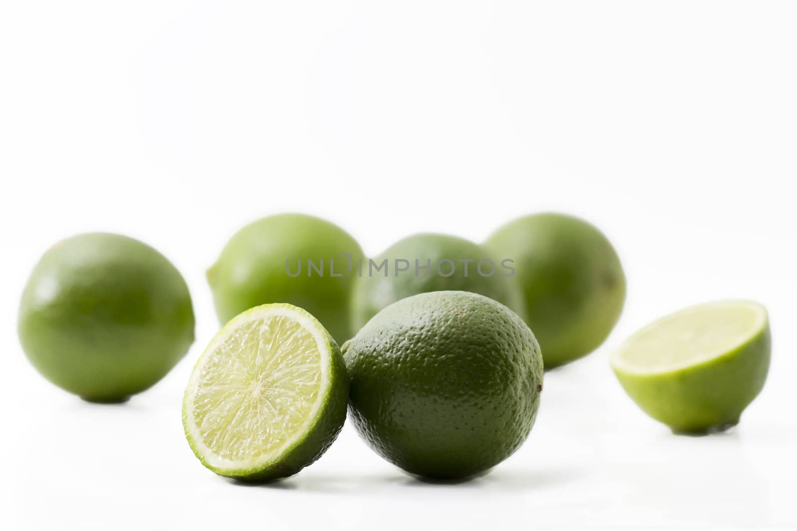 some limes and halfes on on white background