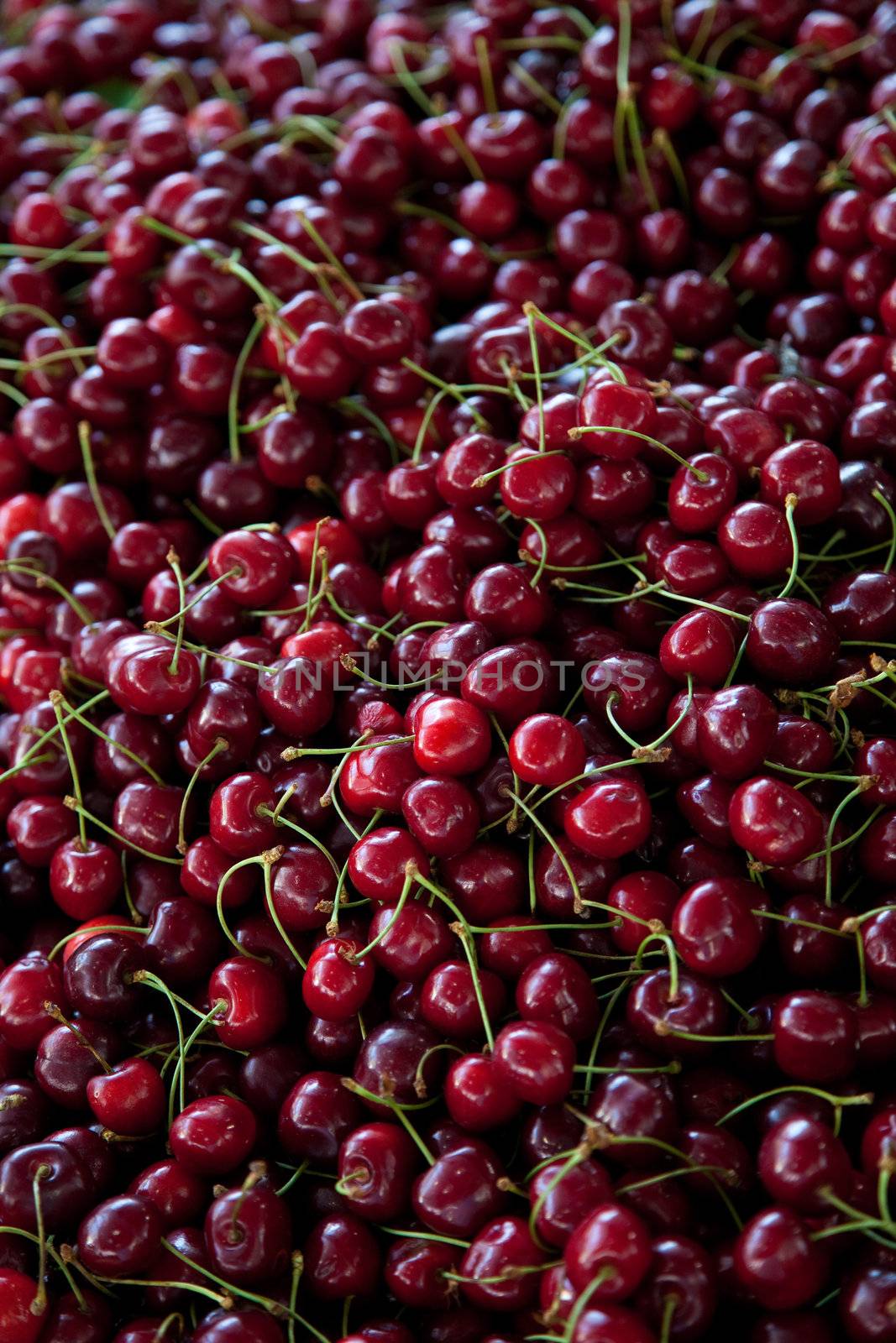 Pile of red cherries waiting to be bought