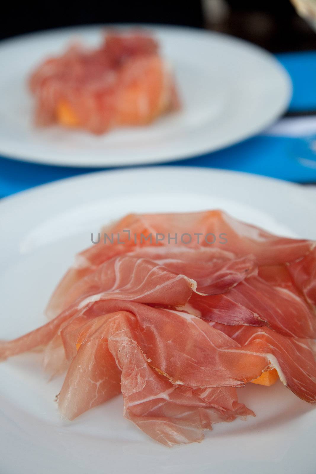 Fresh appetizer with prosciutto and melon on a plate
