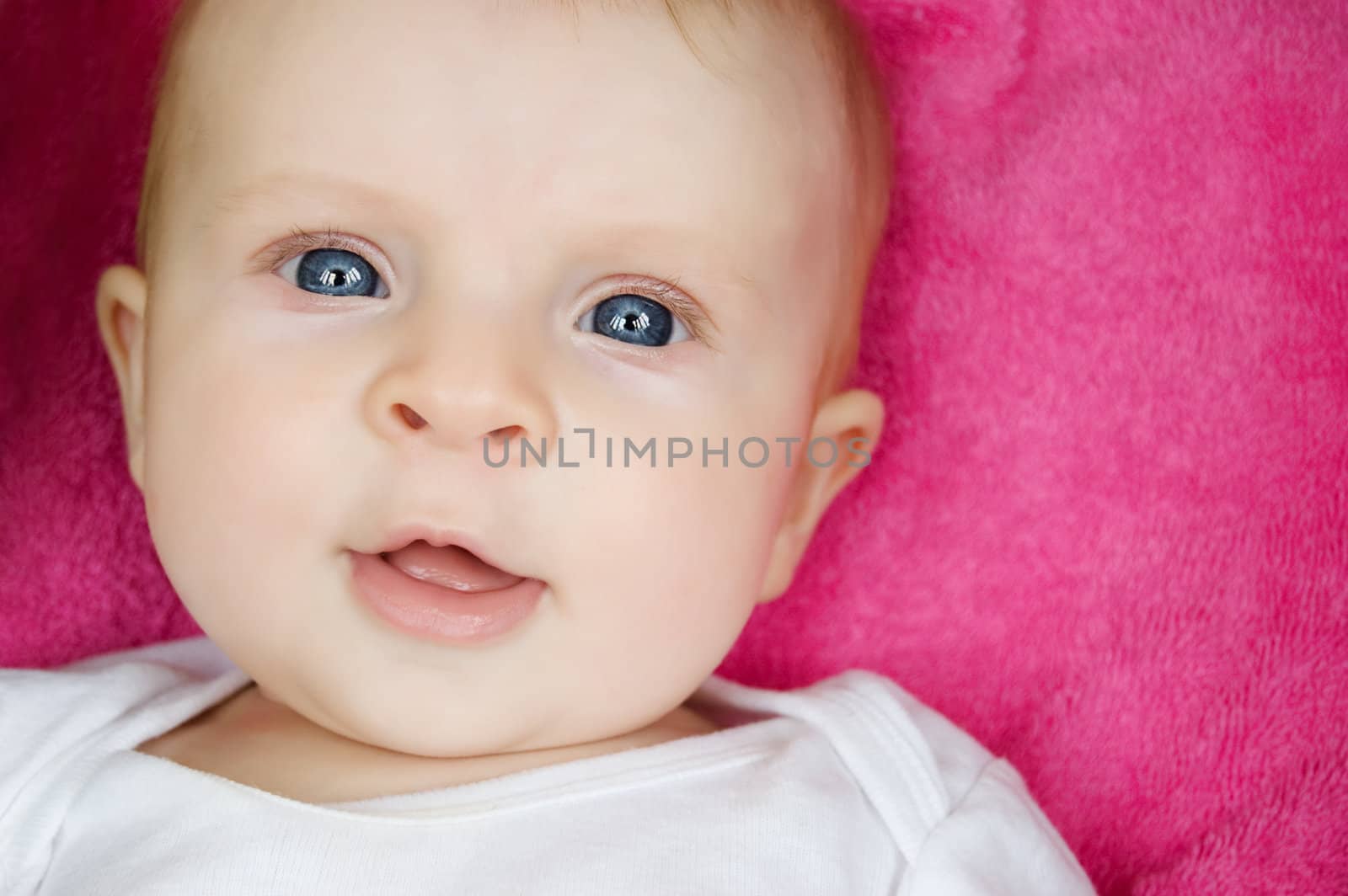 Blue eyed baby girl closeup portrait