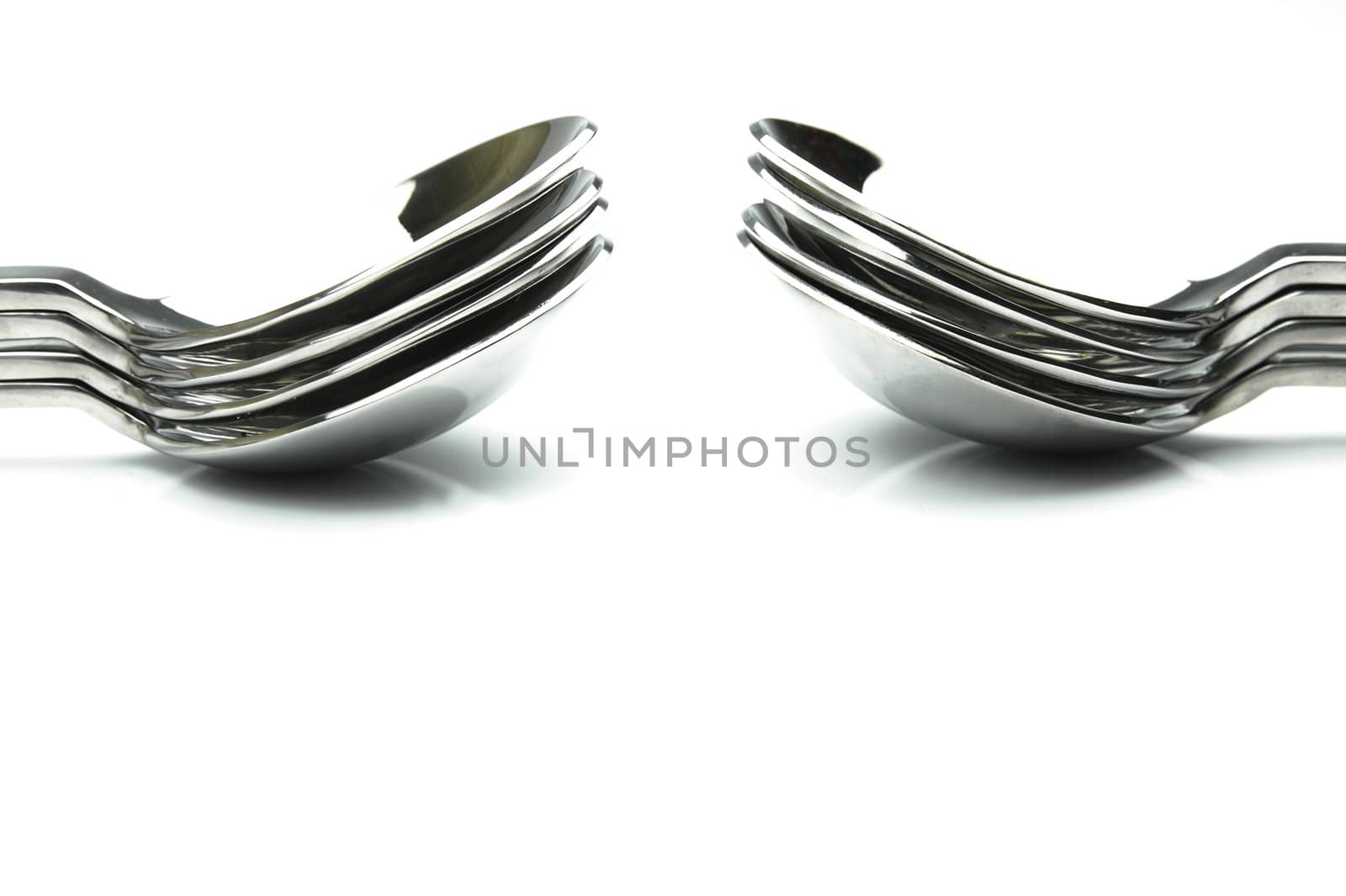 Silver desert spoons isolated against a white background