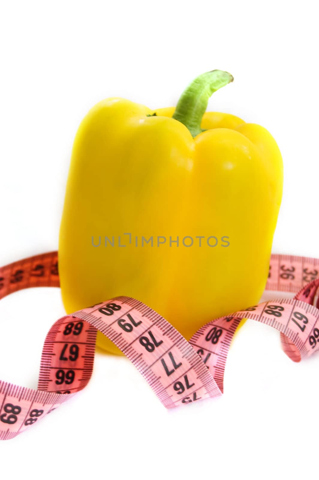 yellow pepper with measuring tape isolated on white