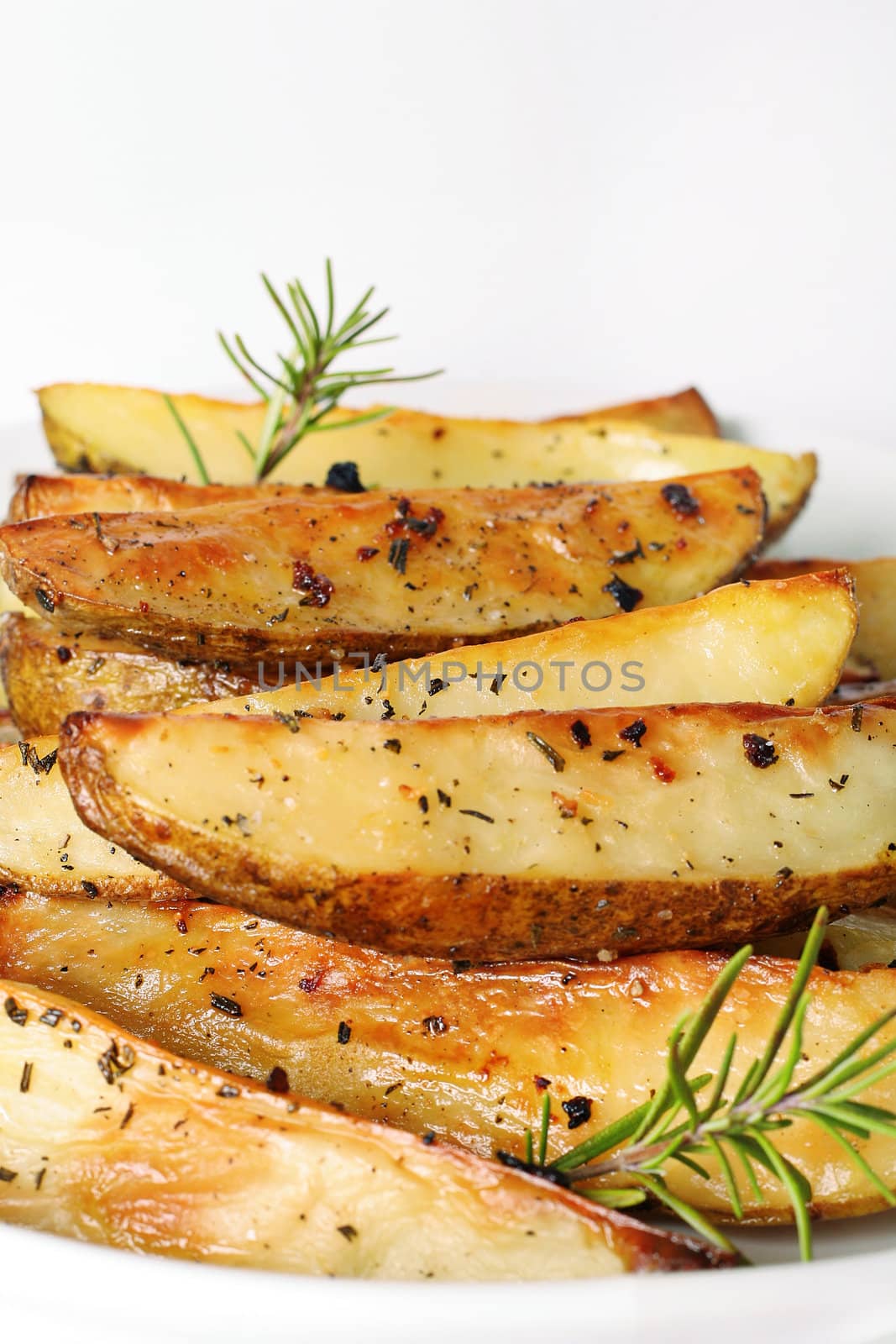 shot of roasted potatoes vertical by creativestock