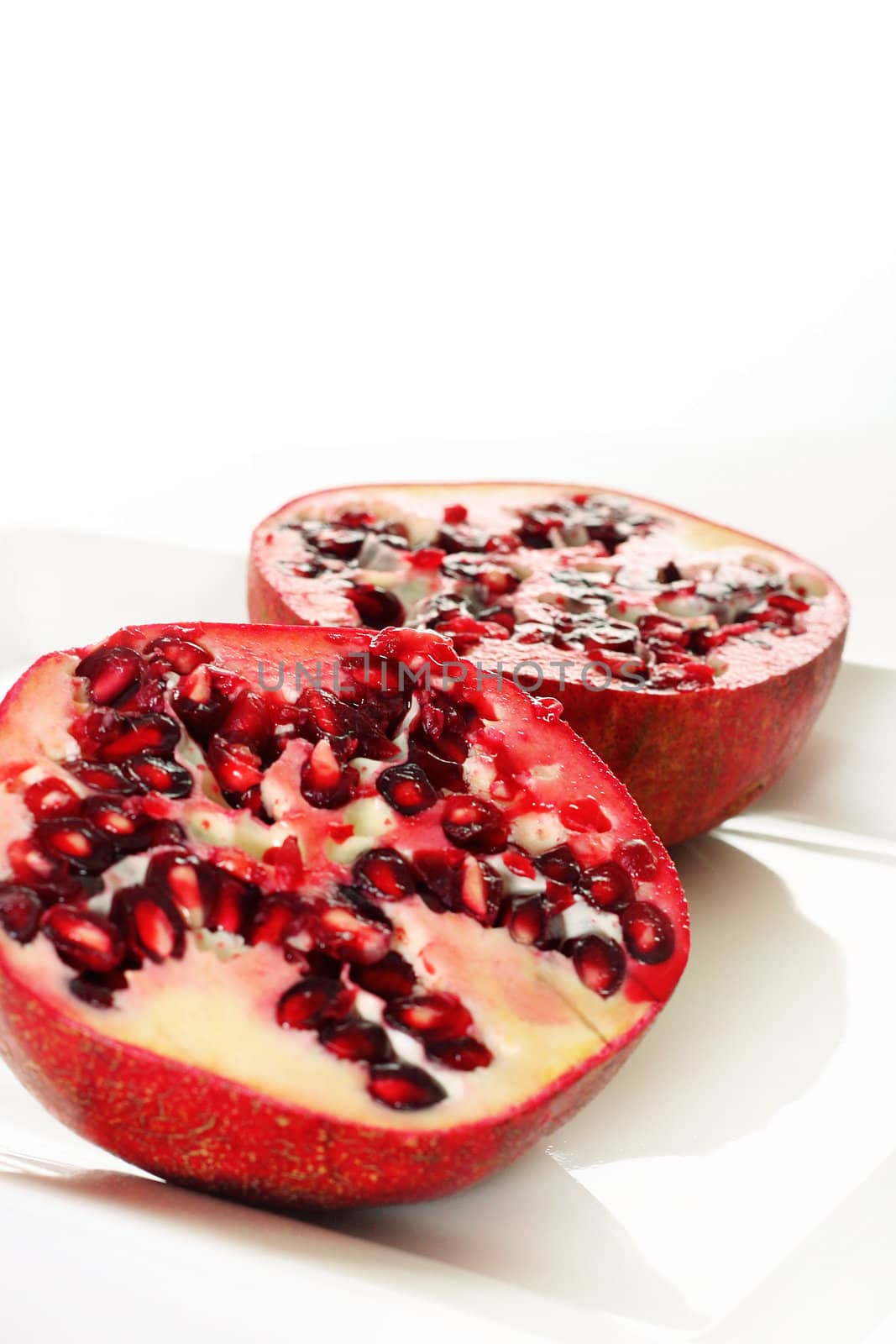 shot of a pomegranate cut vertical by creativestock