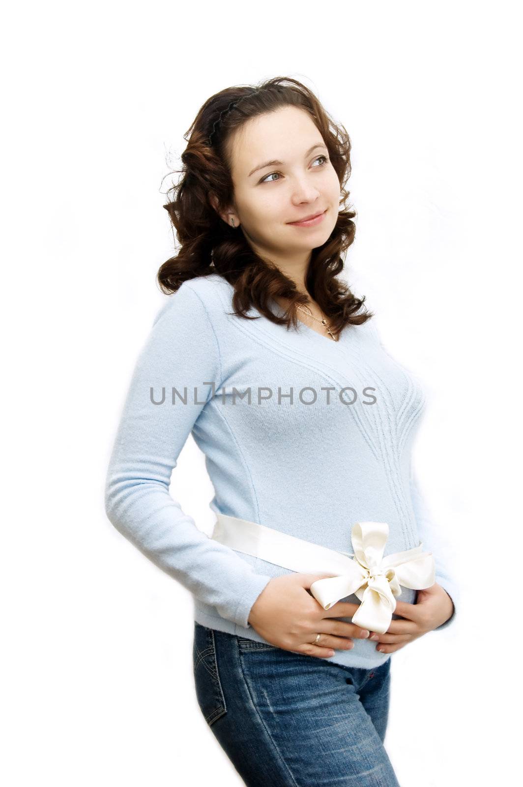 Beautiful pregnant woman with bow on belly like gift